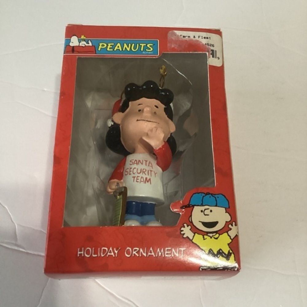 Peanuts Lucy Holiday Ornament Lucy in a “Santa Security Team” T-shirt